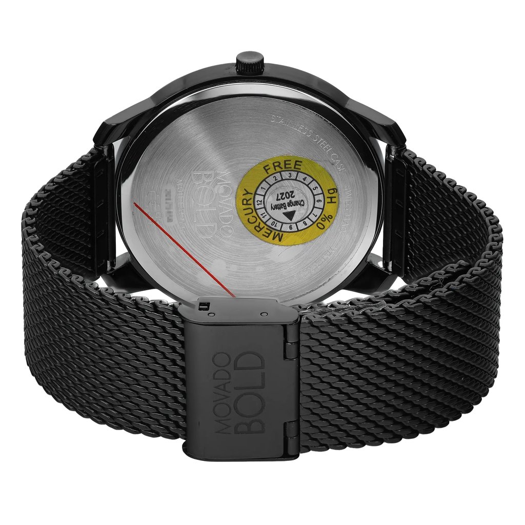 An image of a wristwatch taken from the back view, showcasing the close clasp. The watch features a stainless steel case and a mesh band. The image is captured at a close distance, focusing on the clasp area, which is engraved with "MOVADO BOLD." The watch is new but noted to have defects.
