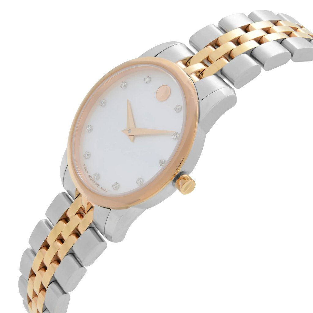 An image of a pre-owned wristwatch viewed from a side profile angle, showcasing the crown prominently. The watch features a two-tone metal bracelet with gold and silver links and a round face with minimalist markers. The distance is close, highlighting the design details.