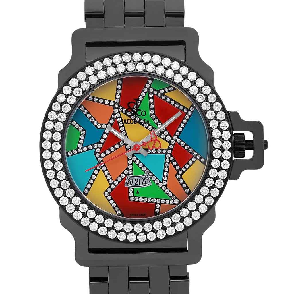 An image of a pre-owned wristwatch shown in a front close-up shot. The watch face features a colorful mosaic design with various geometric shapes in red, blue, green, yellow, and orange. The watch has a silver-tone bezel encrusted with two rows of sparkling stones. Silver hour and minute hands, along with a red second hand, are visible. The date display is positioned at the 6 o'clock mark. The watch is set against a sleek, dark metal bracelet.