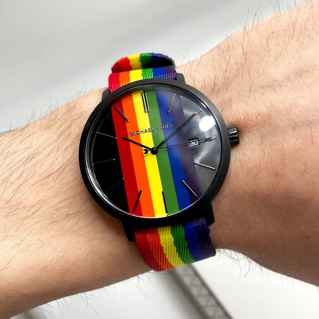 An image of a Wristwatch by Michael Kors. This New With Defects item is designed for Unisex Adult, featuring a Casual,Dress/Formal style. It has a Quartz movement and an Analog display with a Multicolor dial color. The indices include 12-Hour Dial,Stick Indexes. The band is made of Nylon and the case is made of Stainless Steel. The watch has a Round shape with a case size of 42 mm and a case thickness of 8 mm.