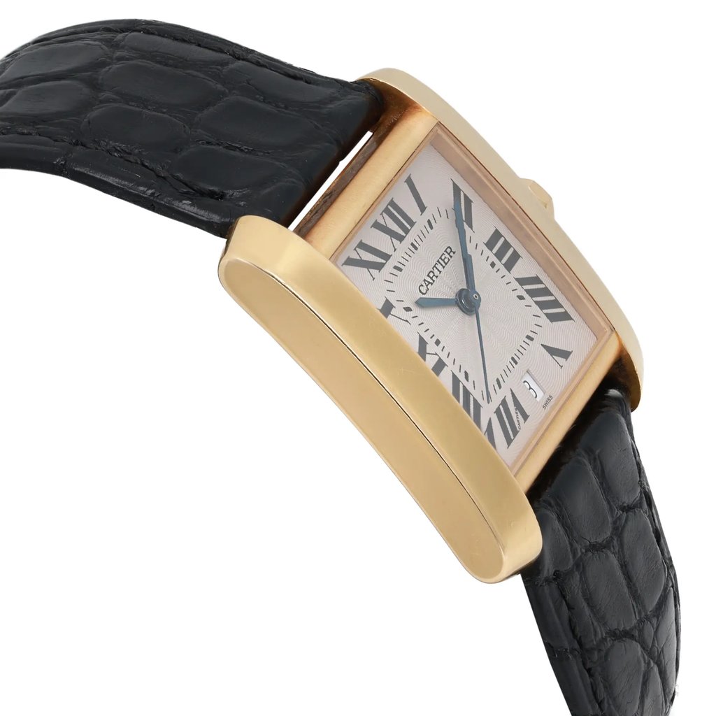 An image of a pre-owned Cartier wristwatch positioned at a slight angle, showcasing its rectangular gold case and black leather strap. The watch face features Roman numerals and a date indicator, with the brand name visible. The photograph captures the watch from a close-up perspective, emphasizing its elegant design and craftsmanship.