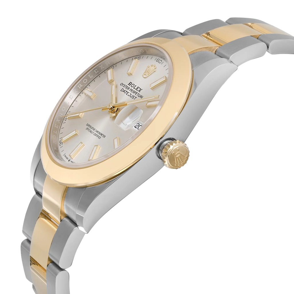 An image of an unworn Rolex men's luxury wristwatch, presented in a side profile view with the crown visible. The watch features a round shape with a silver sunburst pattern dial and a gold bezel. The date indicator is visible at the 3 o'clock position, and the hands are luminous. The band is made of stainless steel and yellow gold, and the case material is stainless steel. The image is taken from a close distance, emphasizing the side angle and the details of the watch's design.