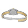 An image of a pre-owned men's Rolex wristwatch showing the back view with an open clasp. The round case and screwback are made of stainless steel, and the band is a combination of stainless steel and solid gold. The watch is positioned at a slight angle with the top facing towards the upper left corner of the image, and the clasp is in the foreground. Minor signs of wear or scratches are visible on the surfaces. The distance is close enough to show detail while capturing the entire back side of the watch.