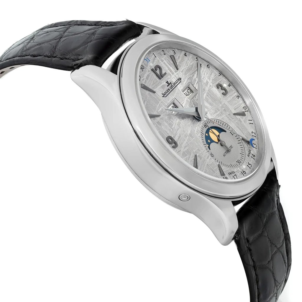 An image of a pre-owned Jaeger-LeCoultre men's luxury wristwatch, positioned at a side profile view opposite of the crown, showcasing its round stainless steel case and gray bezel. The watch has a silver meteorite dial with a moon phase feature and a small seconds subdial, complemented by a black leather band. The image is taken at a close distance, allowing for a clear view of the watch's side, with visible light signs of wear and minor scratches.