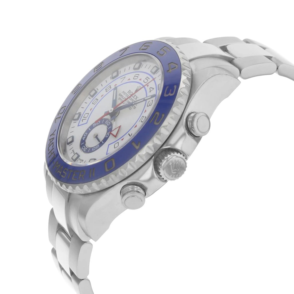 An image of a pre-owned wristwatch shown from a side profile view. The focus is on the crown and buttons, highlighting the watch's detailed design. The timepiece features a metallic band and a bezel with blue accents, emphasizing its elegant and robust build. The angle captures the watch at a close distance, showcasing its intricate craftsmanship.