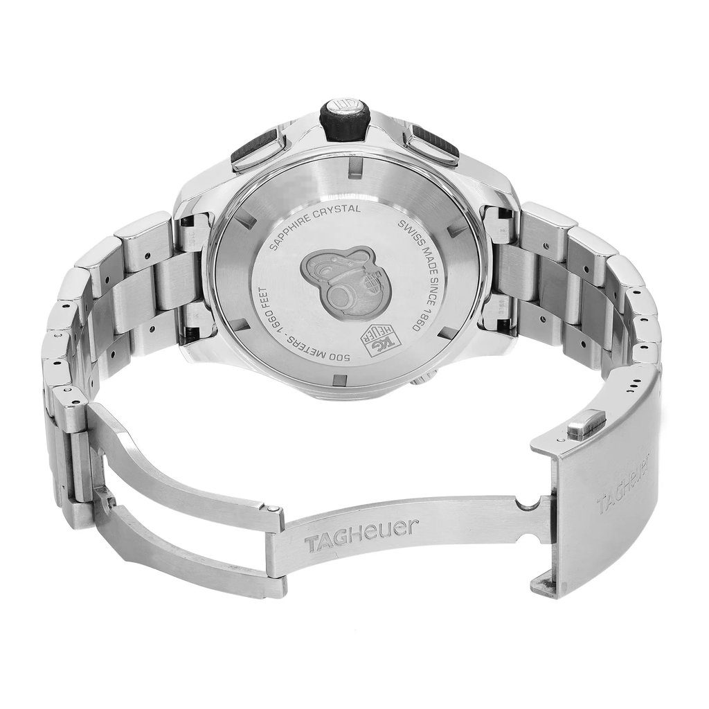 An image of a pre-owned TAG Heuer men's wristwatch viewed from the back, with the open clasp prominently displayed. The stainless steel case and band are visible, showcasing the solid caseback and fold-over clasp with a double push button. The watch is positioned at an angle that highlights the craftsmanship and design details, including the engraved text on the caseback. The distance captures the entire watch, focusing on the back view and open clasp.