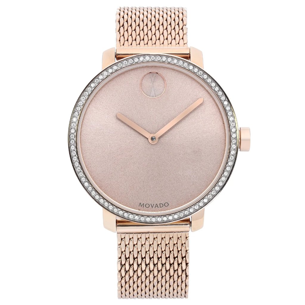 An image of a pre-owned wristwatch taken from a full frontal view. The watch features a rose gold mesh band and a minimalist dial with rose gold hands. The bezel is adorned with small crystals, adding a touch of elegance. The photo captures the watch at a close distance, highlighting its design details.
