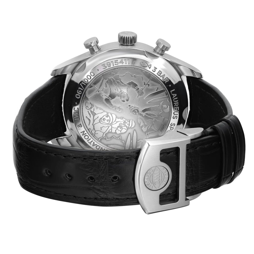 An image of a pre-owned IWC men's wristwatch viewed from the back. The stainless steel screwback case is shown at an angle, highlighting the engraved detail on the caseback. The watch has a round shape and is fitted with a black leather band, which is partially looped and secured with a deployant clasp visible on the right. The watch is positioned against a white background, with the back of the watch face occupying the central part of the frame and the band extending to the left, giving a clear view of the watch's design and construction.