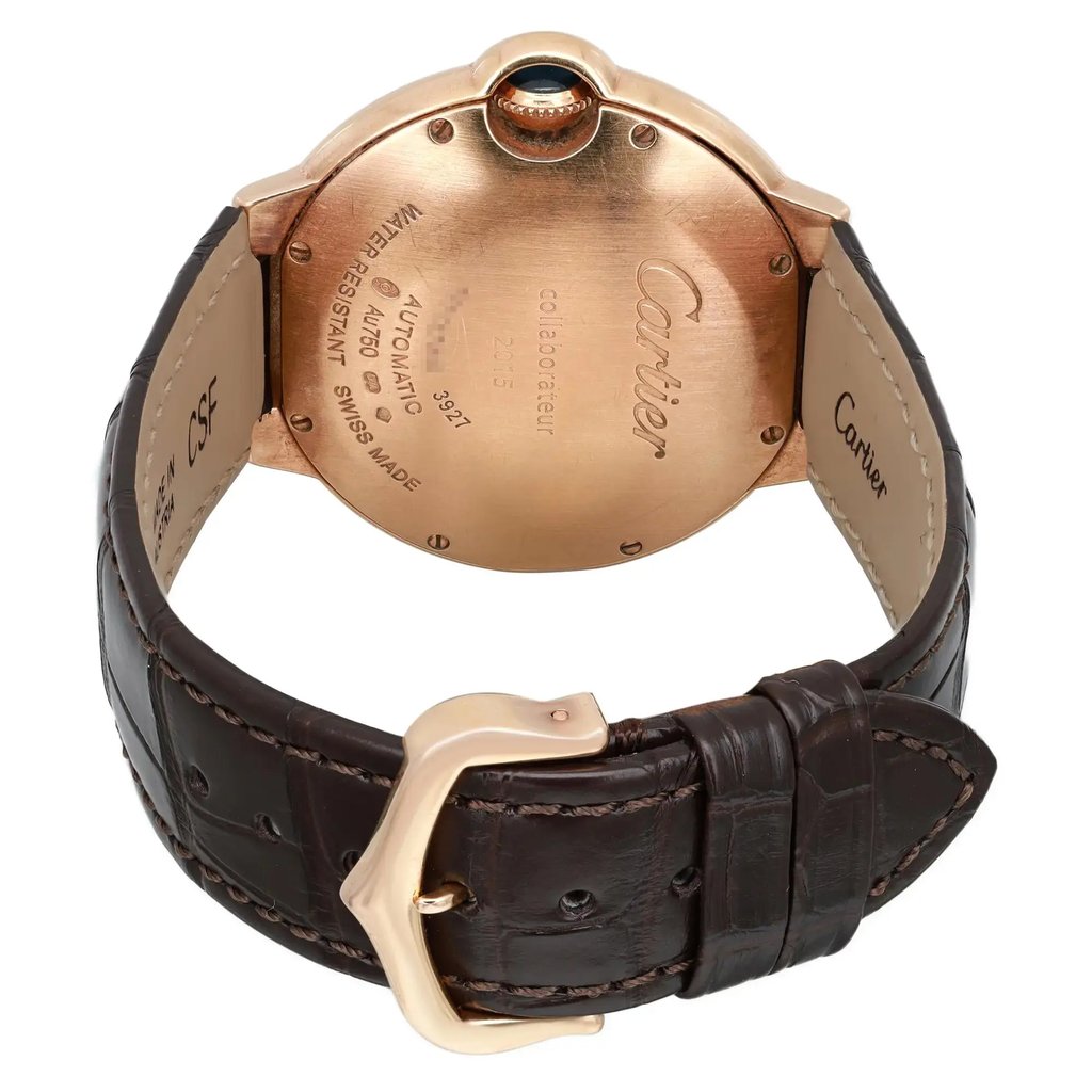 An image of a pre-owned wristwatch viewed from the back, showcasing a close-up of the clasp. The watch features a gold-toned case with engraved details and a dark brown leather strap. The angle highlights the texture of the strap and the clasp's design, offering a clear view of the watch's craftsmanship.