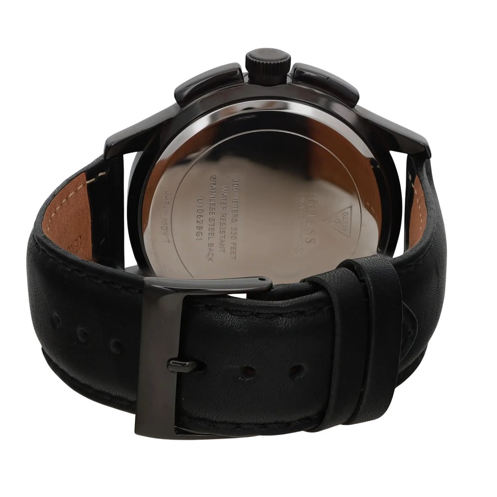 An image of a pre-owned men's GUESS wristwatch, shown from the back at a close distance and slightly angled upward. The focus is on the stainless steel case back, with visible engravings, and the attached black leather strap featuring a buckle clasp. The watch includes features like a chronograph, date indicator, and luminous hands.