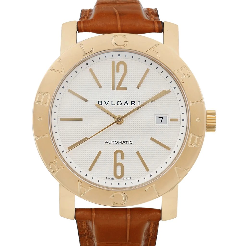 An image of a pre-owned men's Bvlgari wristwatch captured from a front-facing angle at a close distance. The watch features a round yellow gold bezel with "BVLGARI" engraved on it, a white dial with gold hour markers, and a date indicator on the right side. It has a brown leather strap attached to the gold case.