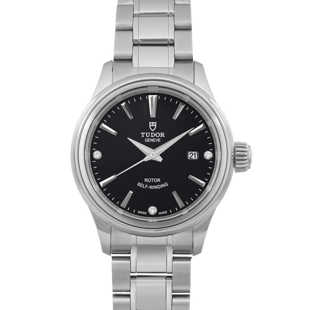 An image of a wristwatch taken from a front close-up angle, showcasing the watch face in detail. The watch features a black dial with silver hour markers and hands, a date window, and a silver stainless steel bracelet. The condition appears unworn, highlighting its pristine finish.