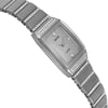 An image of an unworn Rado women's luxury wristwatch with a side profile view opposite of the crown. The watch features a silver dial and bezel, with a white gold band and case. The rectangle-shaped watch is captured in close-up, showing the left side angle, highlighting the smooth finish and sparkling embellishments along the band and dial area.