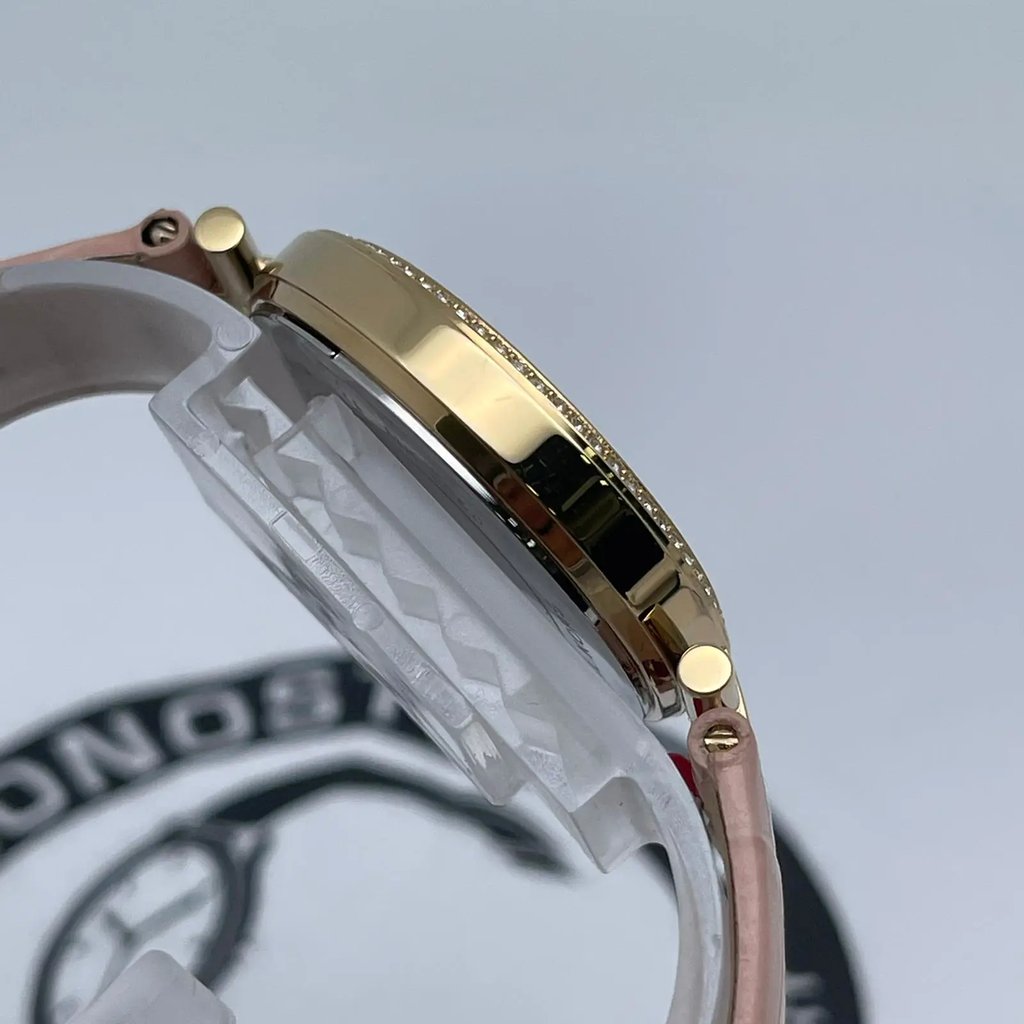 An image of a Wristwatch by Michael Kors. This New With Defects item is designed for Women, featuring a Casual,Dress/Formal style. It has a Quartz movement and an Analog display with a Pink dial color. The indices include 12-Hour Dial,Non-Numeric Hour Marks,Roman Numerals,Stick Indexes. The band is made of Leather and the case is made of Stainless Steel. The watch has a Round shape with a case size of 34 mm and a case thickness of 8 mm.