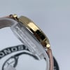 An image of a Wristwatch by Michael Kors. This New With Defects item is designed for Women, featuring a Casual,Dress/Formal style. It has a Quartz movement and an Analog display with a Pink dial color. The indices include 12-Hour Dial,Non-Numeric Hour Marks,Roman Numerals,Stick Indexes. The band is made of Leather and the case is made of Stainless Steel. The watch has a Round shape with a case size of 34 mm and a case thickness of 8 mm.