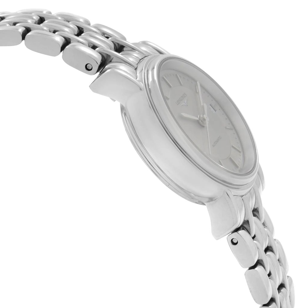 An image of a wristwatch viewed from the side profile, opposite the crown. The watch is a display model with a polished metal bracelet and a smooth, rounded case. The angle highlights the sleek design and detail of the watch face, which is partially visible. The image is taken from a close distance, capturing the texture and shine of the materials.