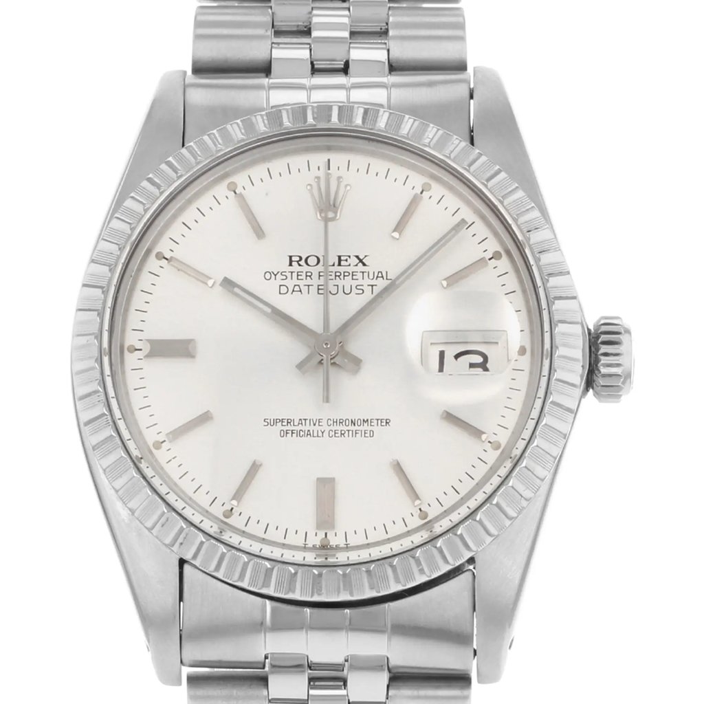An image of a pre-owned wristwatch taken from a front close-up angle, showcasing the detailed watch face. The watch features a silver dial with hour markers, a date display, and a stainless steel bezel and bracelet. The brand name is visible on the dial.