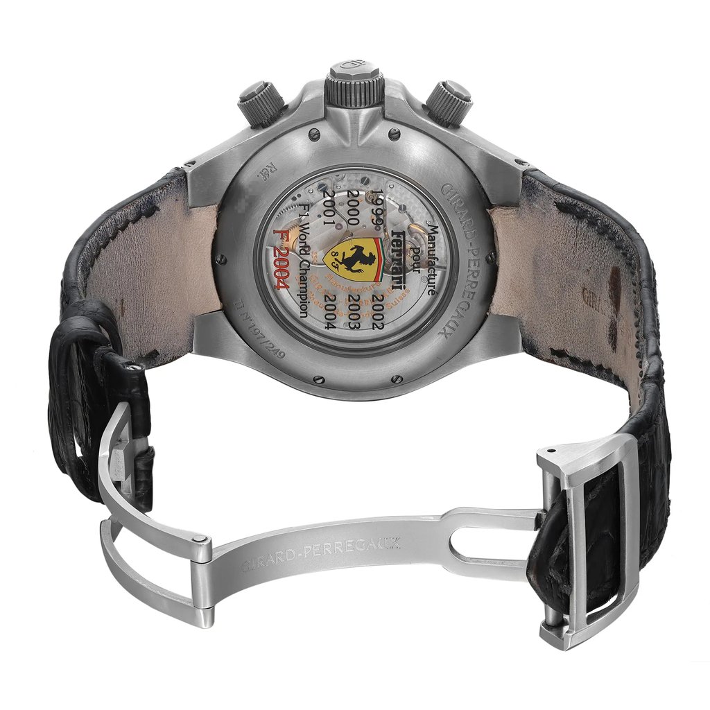 An image of a pre-owned wristwatch viewed from the back, showcasing an open clasp. The angle reveals the inner mechanics and branded engravings on the back case. The watch is positioned centrally, with the clasp open, and captured from a close distance to highlight its details and condition.