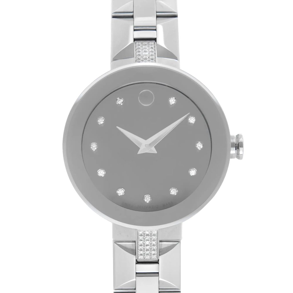 An image of a wristwatch taken from a front close-up angle, showcasing the watch face prominently. The watch features a sleek, minimalist design with a silver-tone face and diamond-like markers. The hands are also silver, and the crown is visible on the right side. The watch's band, also silver, is partially visible at the top and bottom of the image. The condition appears to be a display model, indicating minimal wear.