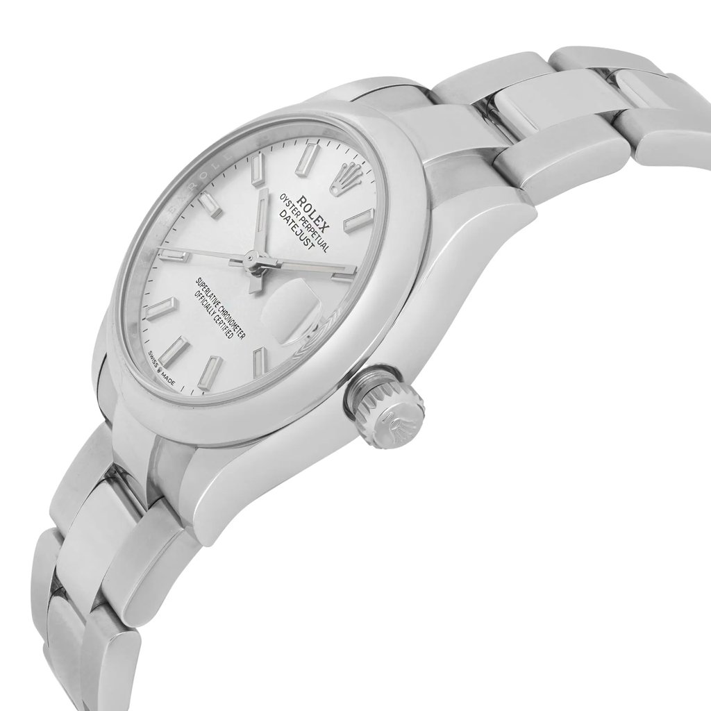 An image of a pre-owned women's Rolex wristwatch, featuring a stainless steel case and bracelet. The watch face is angled slightly to the left, displaying a classic silver dial with silver hour markers and hands. The Rolex logo and "Oyster Perpetual Datejust" are visible on the dial. The crown is prominently positioned on the right side, and the image captures the watch at a close distance, highlighting its elegant design and craftsmanship.