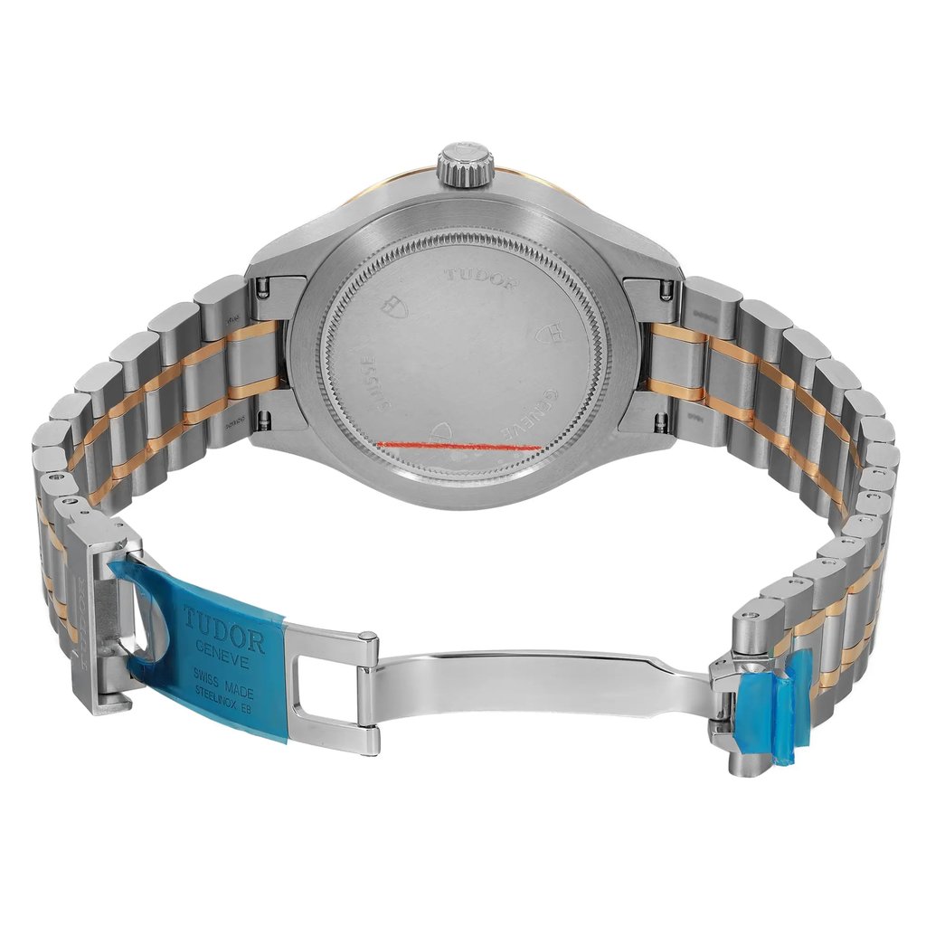 An image of an unworn wristwatch showcasing the back view with an open clasp. The watch is positioned centrally, with the camera angle directly facing the back of the watch case and bracelet. The bracelet features a two-tone design and the clasp is highlighted with blue protective film. The shot is taken at a close distance, emphasizing the details of the watch's back and bracelet.
