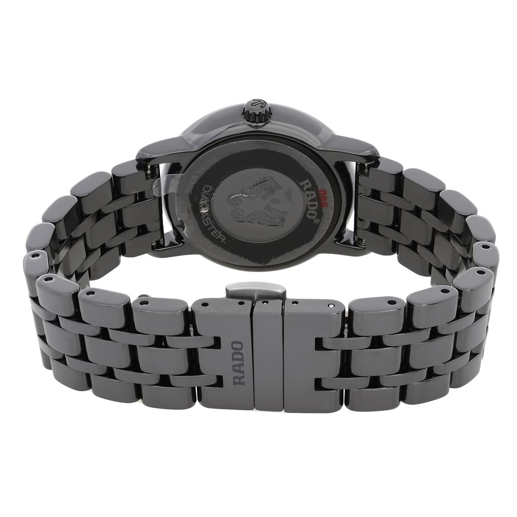 An image of a wristwatch taken from the back view, showcasing the closed clasp. The angle is slightly elevated, focusing on the bracelet links and the watch's back casing. The watch appears new but has defects, and the brand "RADO" is visible on the clasp. The shot is taken at a close distance, highlighting the details of the metal finish and design.