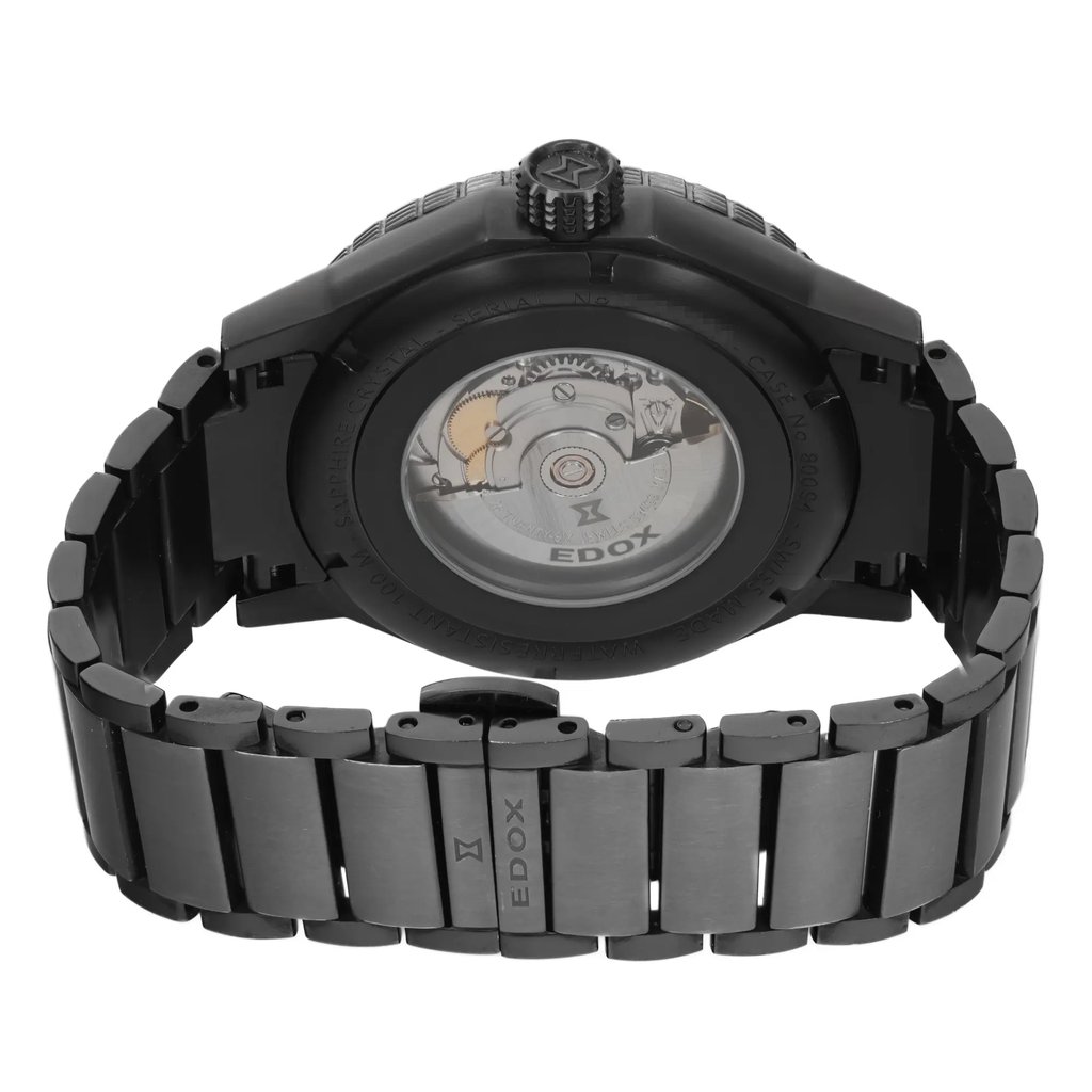 An image of a pre-owned wristwatch showcasing the back view at a close distance. The focus is on the open clasp and the transparent case back, which reveals the internal mechanical components. The watch has a dark metal bracelet with visible links and the brand name "Edox" inscribed on the clasp.