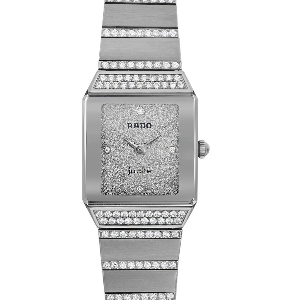An image of an unworn Rado women's luxury wristwatch with a front close-up view of the watch face. The dial and bezel are silver-colored, and the rectangle-shaped case and band are made of white gold. The watch features diamond markers on a 12-hour dial and is presented in an excellent condition class. The band is adorned with diamonds, and the image is taken from a direct, centered angle, showcasing the full front view of the watch.