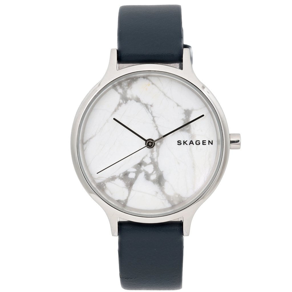 An image of a Skagen women's wristwatch taken from a straight-on angle. The watch features a round face with a marbled white background and minimalist black hands. The brand name "Skagen" is positioned on the right side of the face. The watch has a silver-toned bezel and a dark strap. The image captures the watch in a close-up view, highlighting its design details.