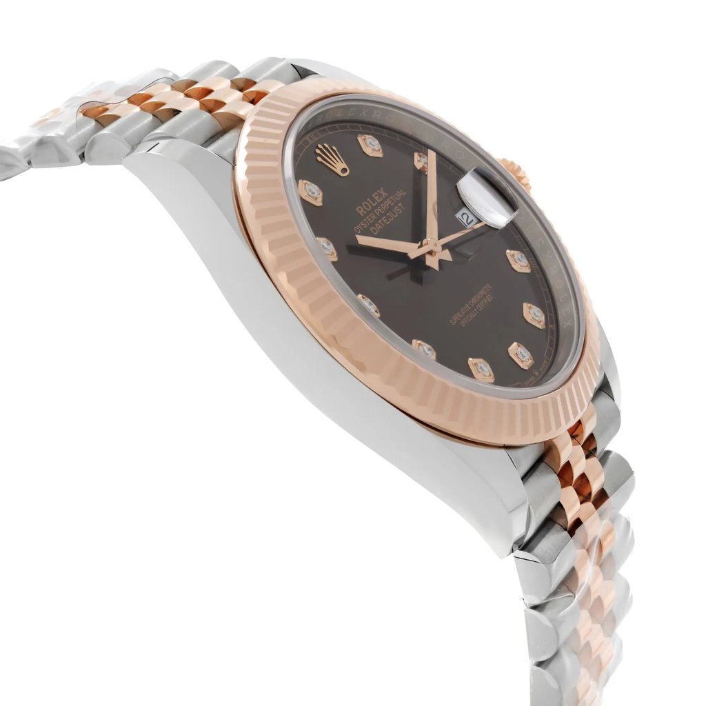 An image of a pre-owned Rolex men's wristwatch in good condition with light signs of wear or scratches. The side profile view is opposite the crown, showcasing the round watch shape at a slight angle. The dial color is chocolate with a sunburst pattern, and the bezel color is rose gold. The band is made of rose gold and stainless steel, while the case material is stainless steel. It is styled as a dress/formal luxury watch. The photo is taken from a close distance, emphasizing the watch's side profile and the contrast between the materials.