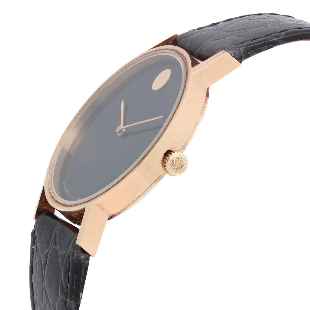 An image of a Wristwatch by Movado. This Pre Owned item is designed for Men, featuring a Classic style. It has a Mechanical (Manual) movement and an Analog display with a Black dial color. The indices include No Hour Marks. The band is made of Leather and the case is made of Stainless Steel. The watch has a Round shape with a case size of 33 mm and a case thickness of 7 mm.