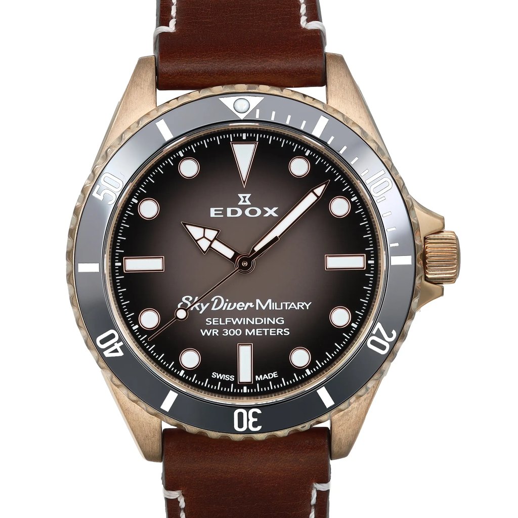 An image of a wristwatch taken from a front close-up angle, showcasing the watch face prominently. The watch features a dark dial with bold, luminous markers and hands. The bezel displays numerals and markers for diving, and the watch is encased in a metallic frame. The brand name and model details are visible on the dial. The watch is attached to a brown leather strap, giving it a classic look. The condition is pre-owned, yet it maintains a polished appearance.