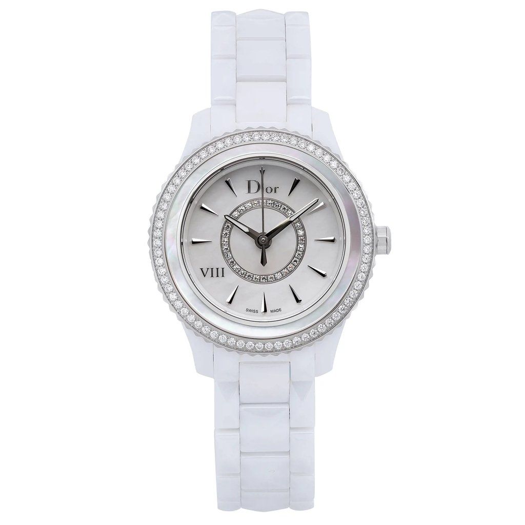 An image of a Wristwatch by Dior. This Display Model item is designed for Women, featuring a Luxury style. It has a Quartz movement and an Analog display with a White dial color. The indices include 12-Hour Dial,Arrow Markers,Non-Numeric Hour Marks. The band is made of Ceramic and the case is made of Ceramic. The watch has a Round shape with a case size of 33 mm and a case thickness of 10 mm.