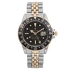 An image of a pre-owned wristwatch taken from a front full frontal view. The watch features a round black dial with a date window and a two-tone metal bracelet. The bezel displays a 24-hour scale. The watch is positioned upright, centered, and captured at a close distance to highlight its details.