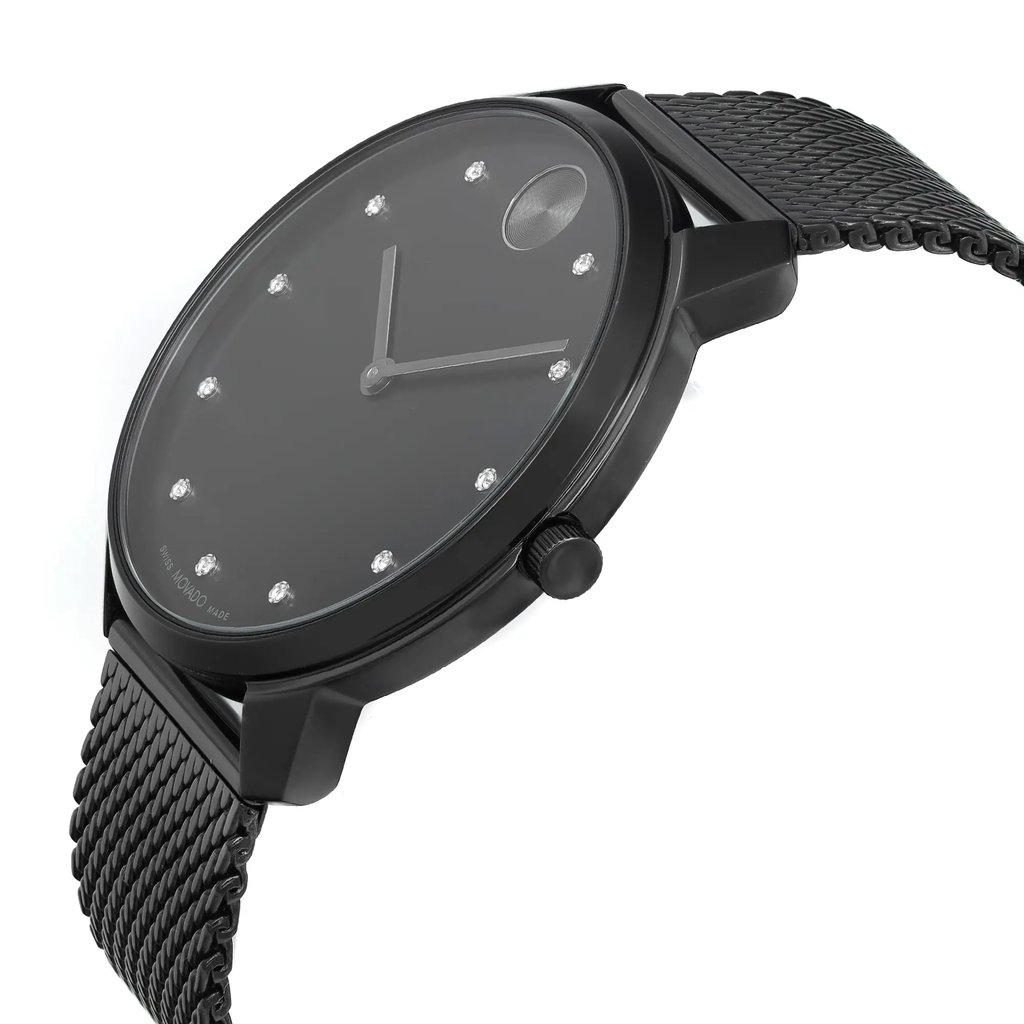 An image of a wristwatch from a side profile view, showing the crown prominently. The watch has a sleek black design with a mesh strap and a minimalist face featuring simple hour markers. The angle highlights the watch's thin profile, and the photograph is taken at a close distance to capture details, emphasizing its modern style despite being new with defects.