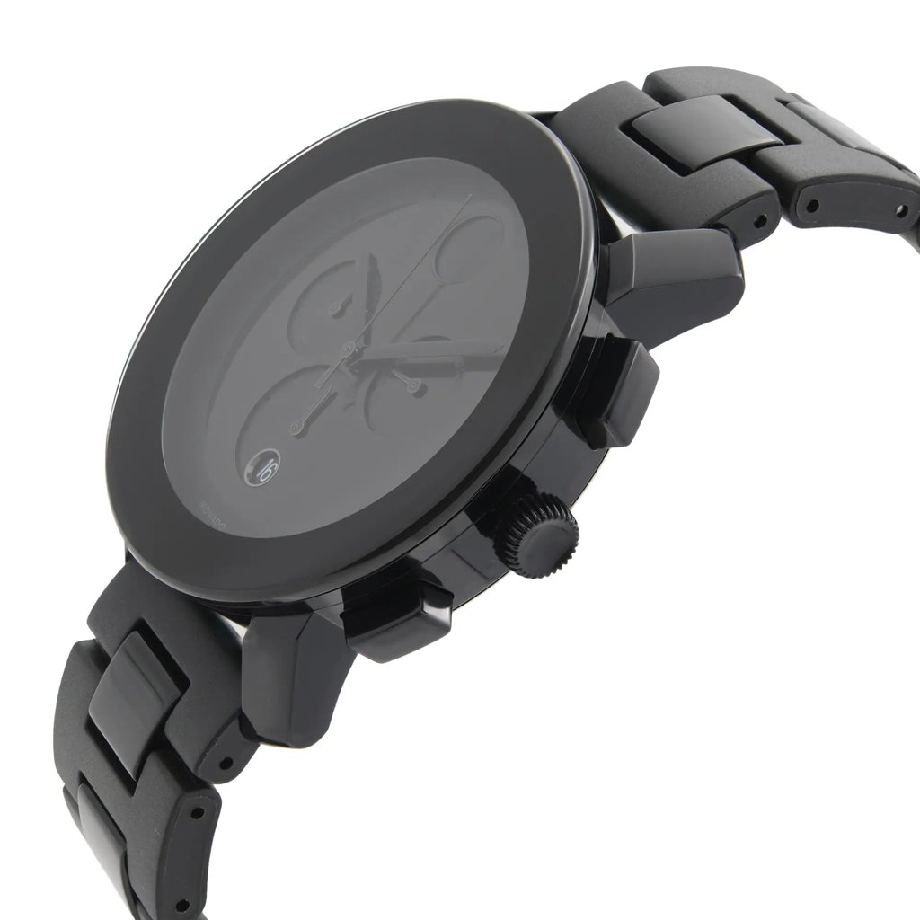 An image of a pre-owned wristwatch viewed from a side profile angle, showcasing the crown prominently. The watch features a black metal bracelet and a round case with two pushers visible. The photo captures the watch at a close distance, highlighting its sleek design and detailing.
