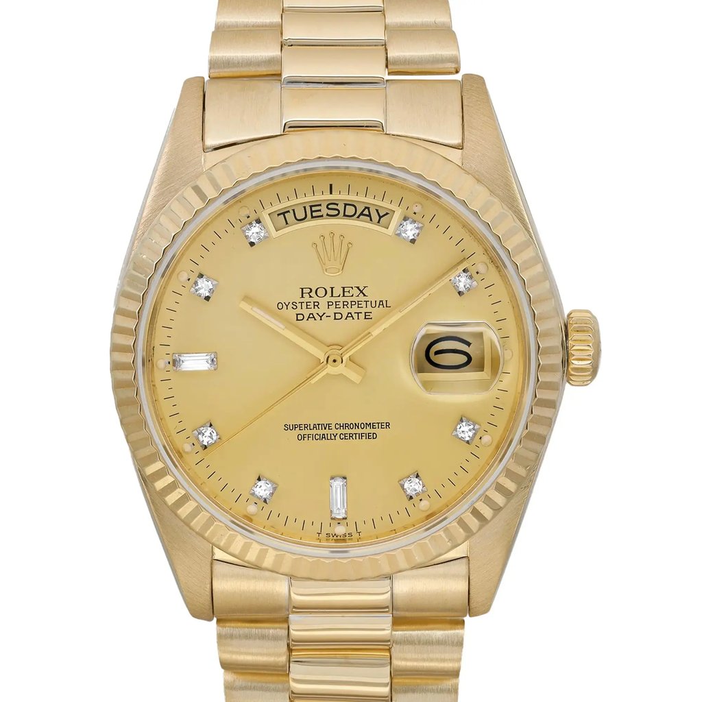 An image of a pre-owned Rolex men's wristwatch in good condition with a front close-up shot focusing on the watch face. The watch features a round case and band made of yellow gold. It has a sunburst gold dial with a day/date display at the 12 and 3 o'clock positions, respectively. The bezel color matches the case and dial, and the indices are stick-style with a 12-hour dial and a seconds hand. Luminous hands are present for improved visibility in low light. Light scratches may be present on the case and bracelet due to age.