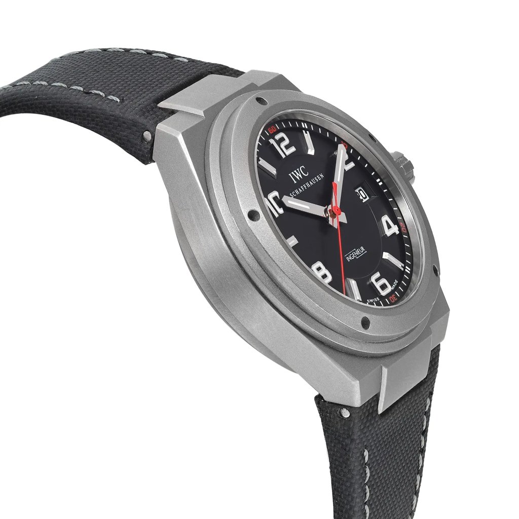 An image of a pre-owned wristwatch viewed from the side profile, opposite the crown. The watch features a robust, metallic case with a black dial and clear numerals. The hands are accented with a red second hand. The strap is black with white stitching, and the watch is positioned at a slight angle, showcasing the depth and detail of the case from a close-up perspective.