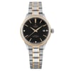 An image of a Tudor Style 28mm women's wristwatch, shown in a front-facing position. The watch is unworn and features a black diamond dial with gold hour markers and hands, including a date indicator at the 3 o'clock position. The casing is steel with a yellow gold bezel, and the bracelet is a two-tone steel and gold design. The image is taken at a close distance, highlighting the details of the watch's design and craftsmanship.