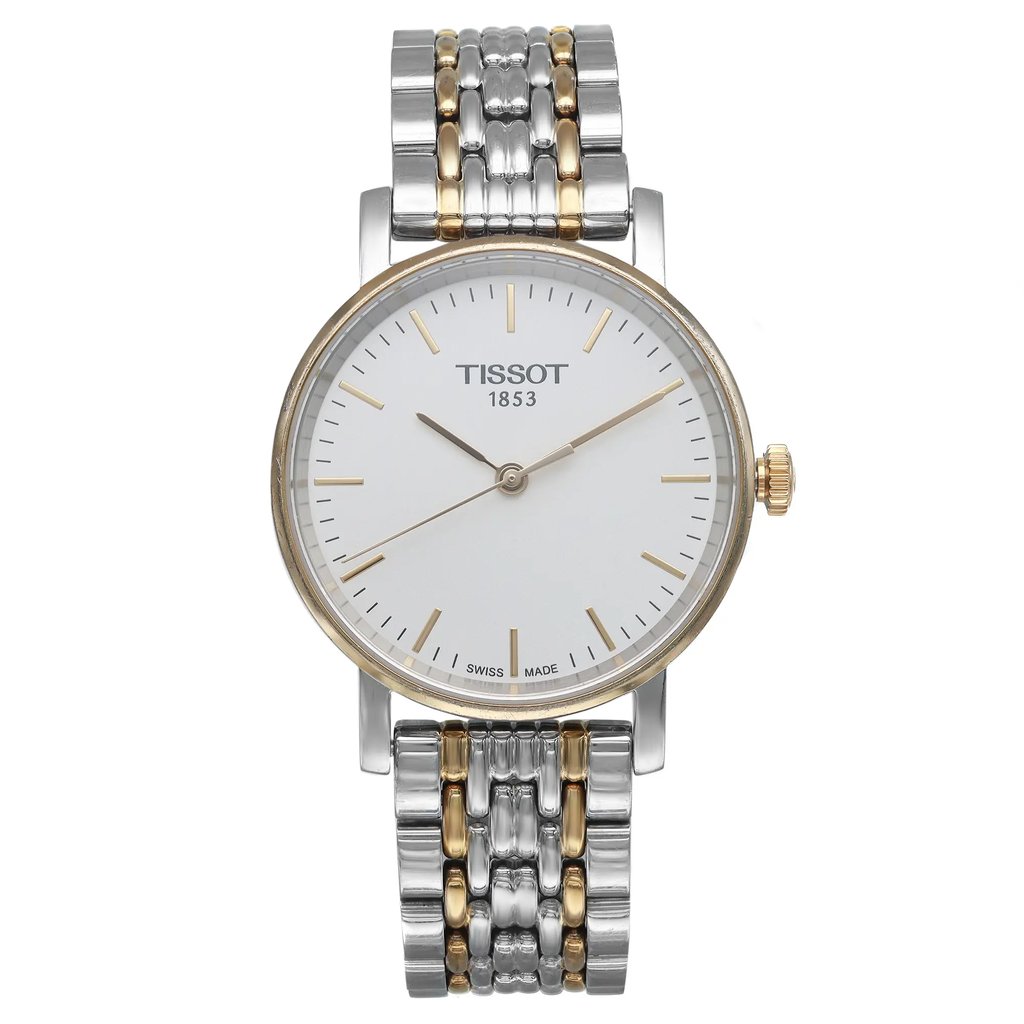 An image of a Wristwatch by Tissot. This Pre Owned item is designed for Women, featuring a Casual style. It has a Quartz movement and an Analog display with a White dial color. The indices include 12-Hour Dial,Stick Indexes. The band is made of Stainless Steel and the case is made of Stainless Steel. The watch has a Round shape with a case size of 30 mm and a case thickness of 6 mm.