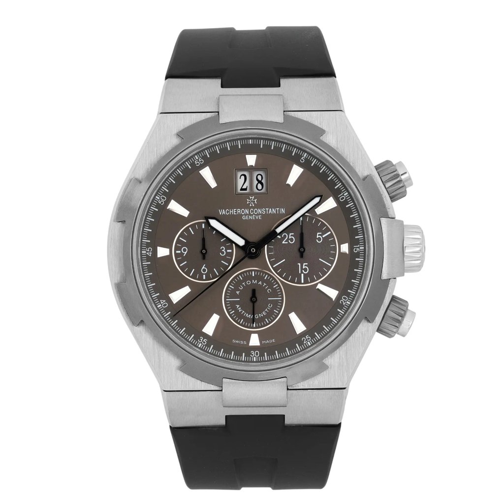 An image of a pre-owned Vacheron Constantin Overseas 42MM Steel Grey Dial Automatic men's wristwatch, captured from a front-facing angle at a close distance. The watch features a silver case with a black rubber strap. It includes a date indicator and luminous hands, with three sub-dials on a dark face. The crown and pushers are visible on the right side.