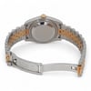 An image of a pre-owned men's Rolex wristwatch, viewed from the back at a slight angle. The watch is positioned upright, showcasing the stainless steel and yellow gold bracelet and the closed clasp. The focus is on the back casing and the band, highlighting the blend of materials. The image is taken from a medium distance, providing a clear view of the bracelet's details and the back of the watch.