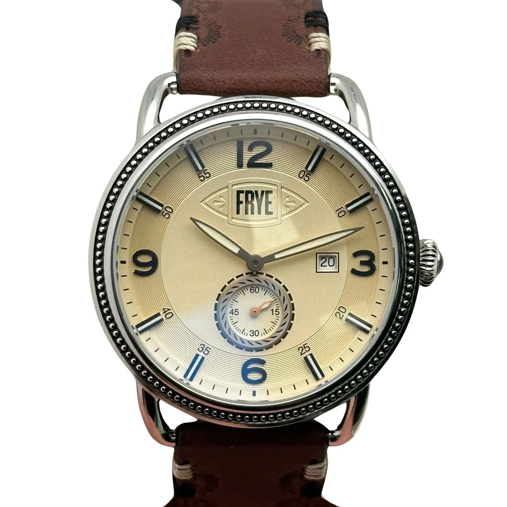 An image of a Wristwatch by Frye. This Unworn item is designed for Men, featuring a Casual style. It has a Quartz movement and an Analog display with a Cream dial color. The indices include 12-Hour Dial,Easy to Read/Large Numerals,Seconds Hand. The band is made of Leather and the case is made of Stainless Steel. The watch has a Round shape with a case size of 47 mm and a case thickness of 13 mm.