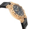 An image of a pre-owned Bvlgari men's luxury wristwatch, presented in a side profile view opposite of the crown. The watch features a round shape with a black dial and gold bezel. It has a yellow gold case and rubber band material, with the brand's name prominently displayed on the black rubber strap. The photo is taken at a close distance, focusing on the side of the watch to showcase its design and the contrast between the gold case and black strap.