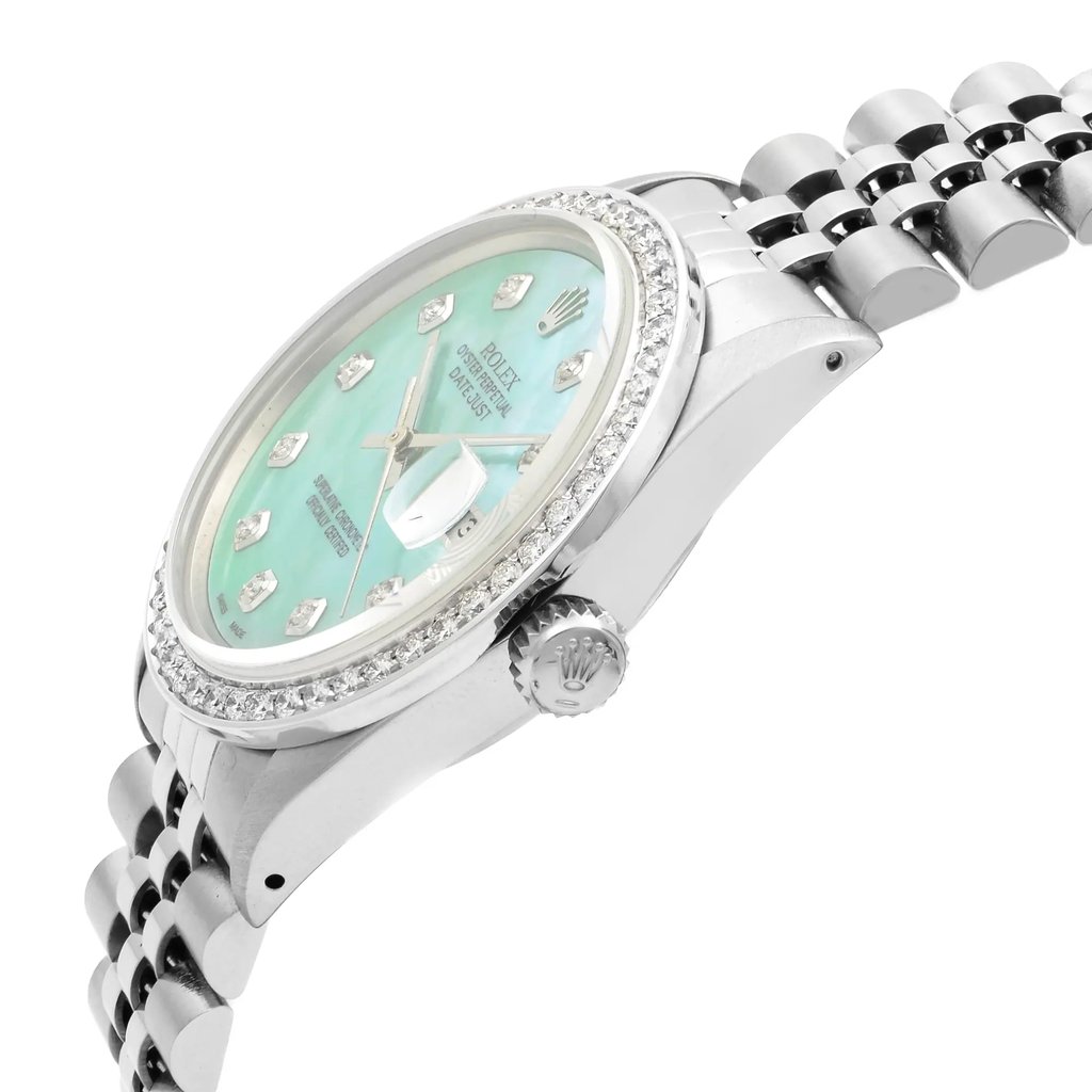 An image of a pre-owned wristwatch captured from a side profile view, showcasing the crown prominently. The watch features a silver metal band and a light blue face, with diamond hour markers. The bezel is adorned with small diamonds, adding a touch of elegance. The angle highlights the watch’s intricate detailing and luxurious design, taken from a close distance.