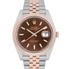 An image of a pre-owned men's Rolex Datejust 41mm wristwatch with a prominent close-up view from the front at a slight upward angle. The watch features a two-tone metal bracelet, a chocolate dial, luminous hands, and a date indicator at the 3 o'clock position. The watch's bezel is a distinctive rose gold color.