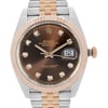 An image of a pre-owned Rolex Oyster Perpetual Datejust men's wristwatch, showcasing a front close-up view of the watch face. The watch is positioned head-on with the camera focused on the dial, capturing fine details from a close distance. The dial features a chocolate sunburst pattern with diamond indices and a date display at 3 o'clock position. A rose gold bezel on the round stainless steel case, complementing the two-tone rose gold and stainless steel band. The watch exhibits good condition with light signs of wear and minor scratches.