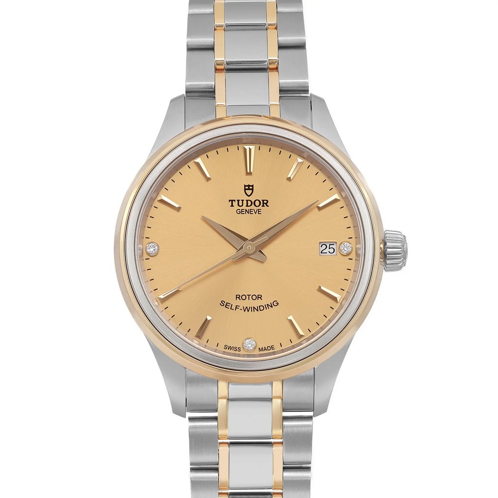 An image of a Tudor women's wristwatch, taken from a direct front view, showing the face and bracelet clearly. The watch features a champagne dial with a date indicator at the 3 o'clock position. The bracelet is a combination of stainless steel and yellow gold, and the watch is in unworn condition. The image captures the details of the watch at a close distance.