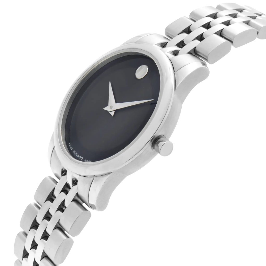 An image of a wristwatch captured from a side profile view, highlighting the crown on the right side. The watch features a sleek, silver-toned case and a black dial with minimalist hour and minute hands. Its stainless steel bracelet is visible, showcasing a polished finish. The angle emphasizes the elegant curvature of the watch, and the image is taken from a close distance to highlight the details of the display model.