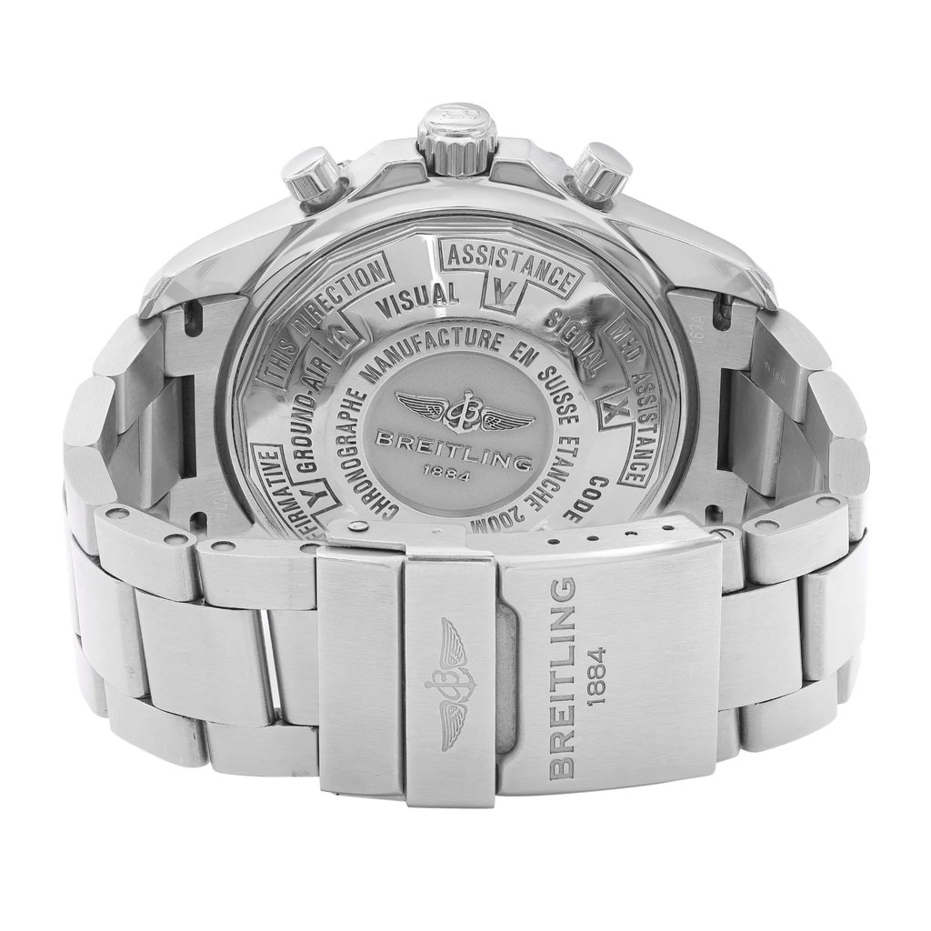An image of a pre-owned Breitling men's wristwatch, viewed from the back shows the caseback and closed clasp. The watch is positioned directly facing the camera at a perpendicular angle, capturing the entire back view in focus. The caseback is screwback stainless steel with engraved text, and the band is also made of stainless steel, featuring a round watch shape. The fold-over clasp with flip lock safety is visibly closed, and the watch appears to be at a close distance, providing a clear view of the details on the caseback and clasp. The watch is pre-owned and may show signs of wear and scratches.